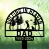 Black metal yard sign silhouette of a golfer swinging under trees with flag, text ‘Golfing in Heaven’ and ‘DAD 1952-2024’ on a soft green garden background