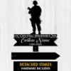 Black silhouette memorial sign of a soldier over text 'In Loving Memory of Custom Name 1986-2026' on a light wood plank background