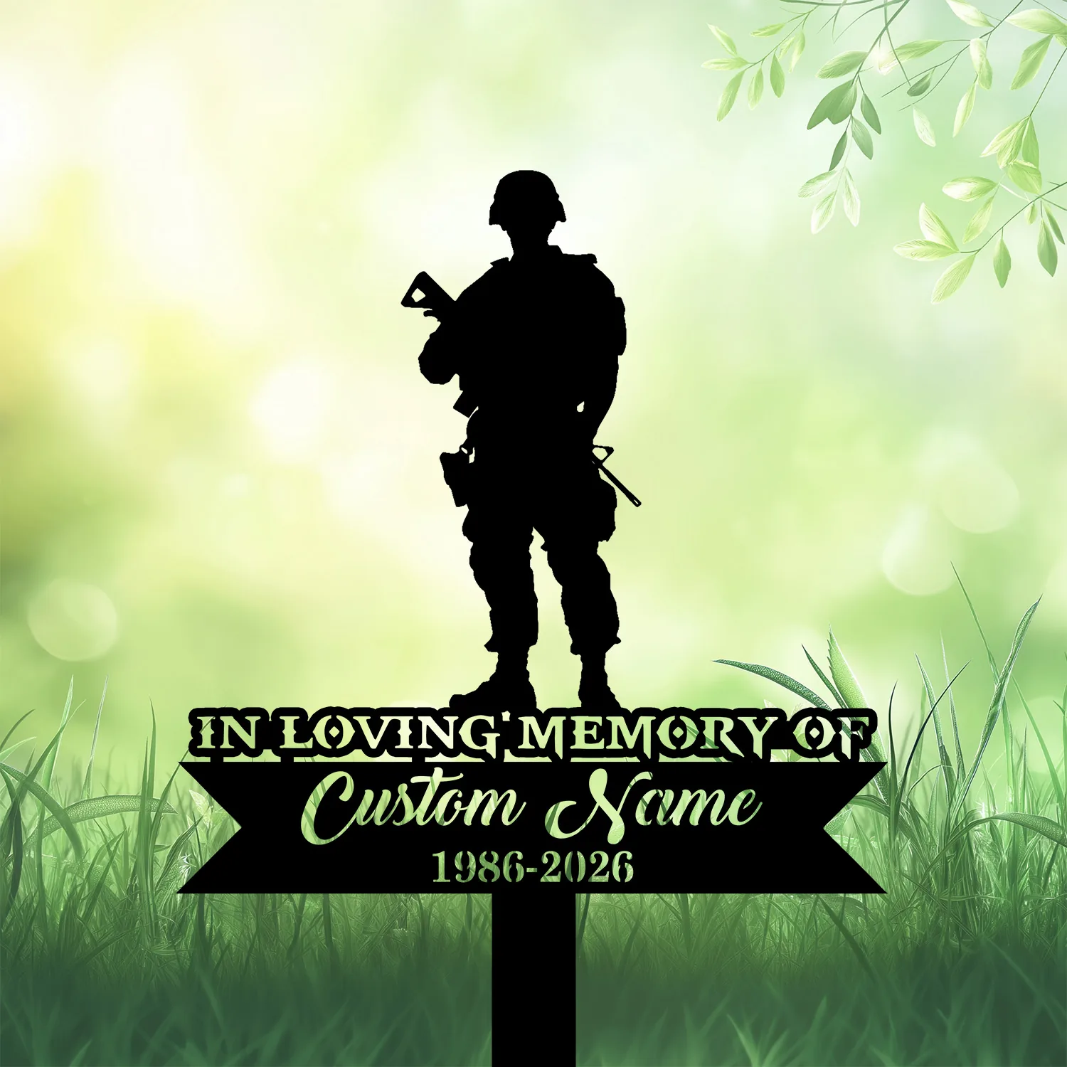 Silhouette of a soldier standing above a black memorial sign reading "In Loving Memory" with placeholder "Custom Name 1986-2026" on green grassy background