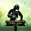 Black silhouette memorial sign of a welder in helmet and apron welding, over green blurred grass background with text placeholder 'In Loving Memory Custom Name 1986-2026'.