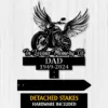 Black metal memorial sign with winged motorcycle and script 'In Loving Memory Of', 'DAD 1949-2024' on a light wood background