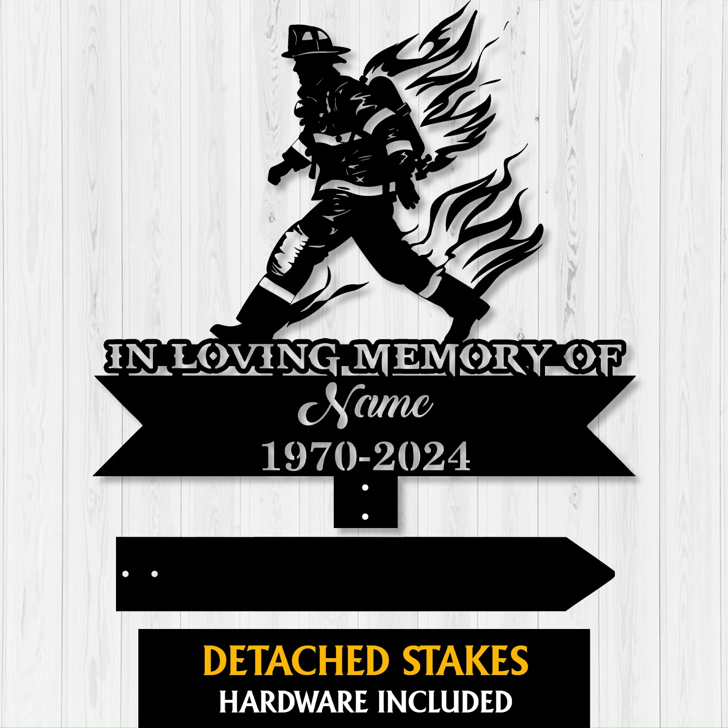 Black metal memorial sign silhouette of a firefighter with flames, text 'IN LOVING MEMORY OF', placeholder 'Name' and dates '1970-2024' on a light wood background