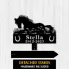Silhouette metal memorial sign of a horse lying in grass with flowers, horseshoes and text 'Stella 2012-2023' on a light wood background