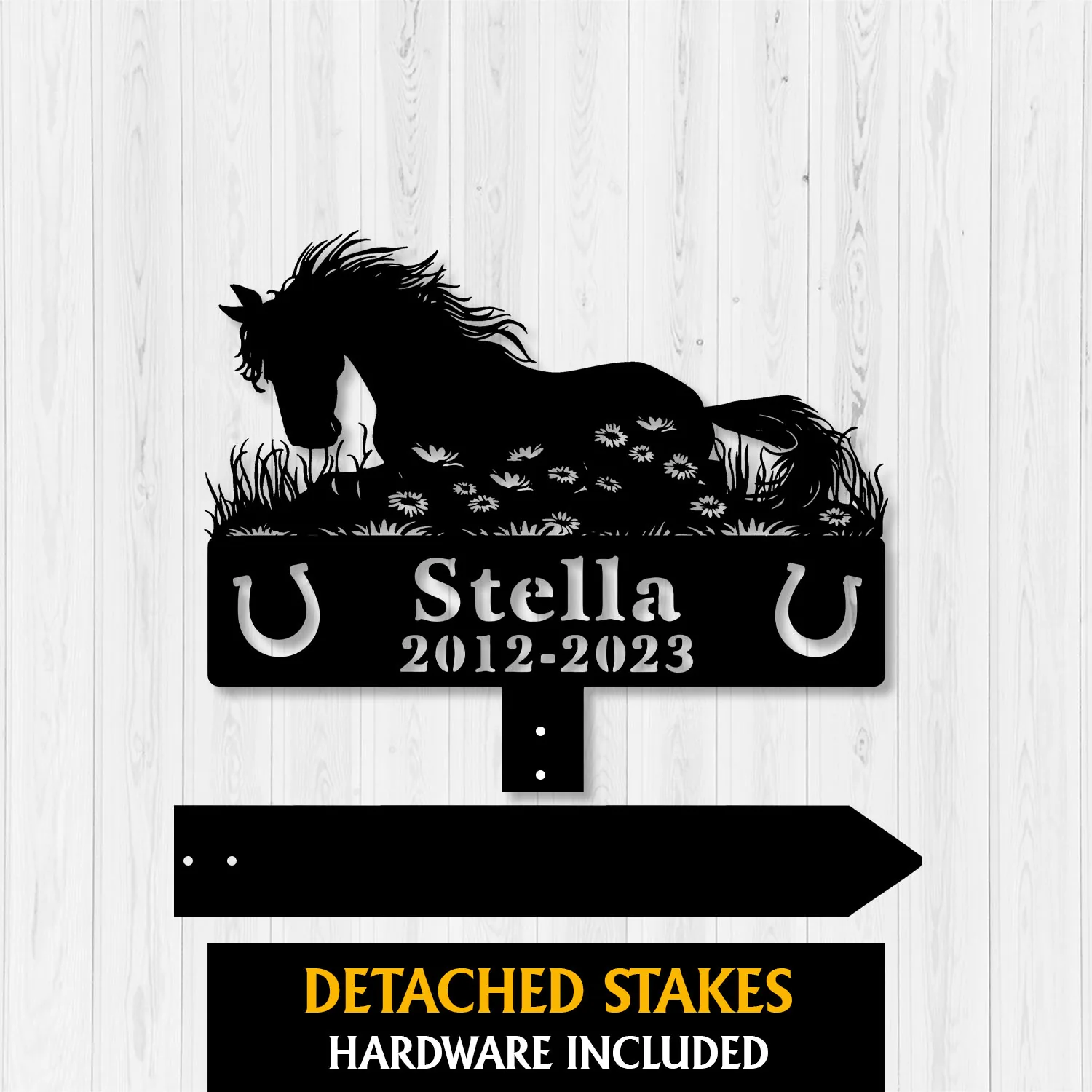 Silhouette metal memorial sign of a horse lying in grass with flowers, horseshoes and text 'Stella 2012-2023' on a light wood background