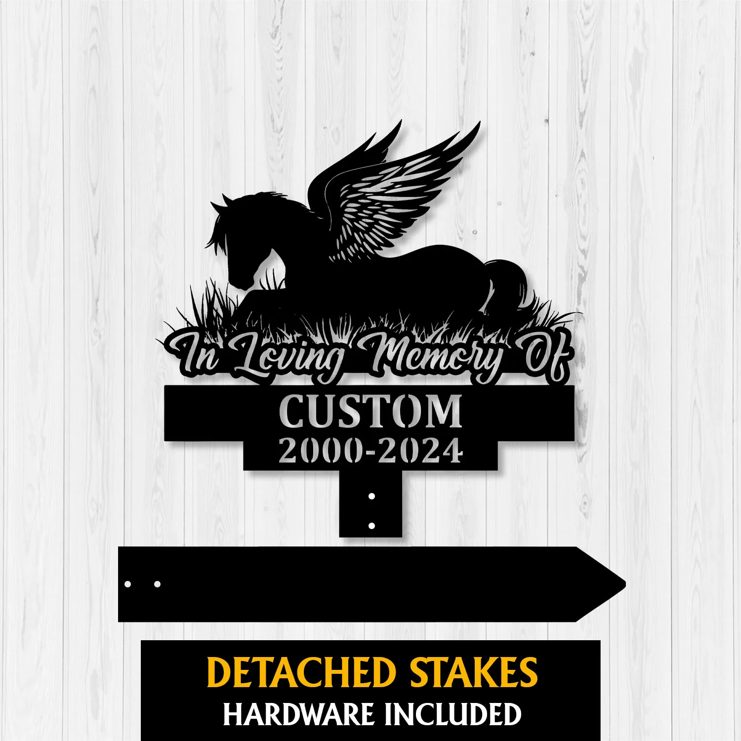 Black metal memorial sign mockup showing a winged horse silhouette above grass with text “In Loving Memory Of” and placeholder name and dates on a white wood background