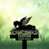 Silhouette memorial sign in grass with winged horse lying down and text "In Loving Memory Of" above customizable name and dates 2000-2024 on green bokeh background
