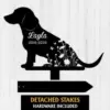 dachshund-4 Black silhouette dog garden stake with name 'Layla' and dates '2015-2025' over floral cutouts, mounted above arrow stake reading 'DETACHED STAKES HARDWARE'