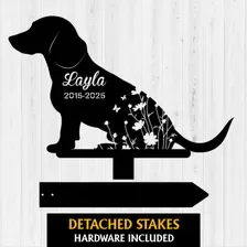 dachshund-4 Black silhouette dog garden stake with name 'Layla' and dates '2015-2025' over floral cutouts, mounted above arrow stake reading 'DETACHED STAKES HARDWARE'