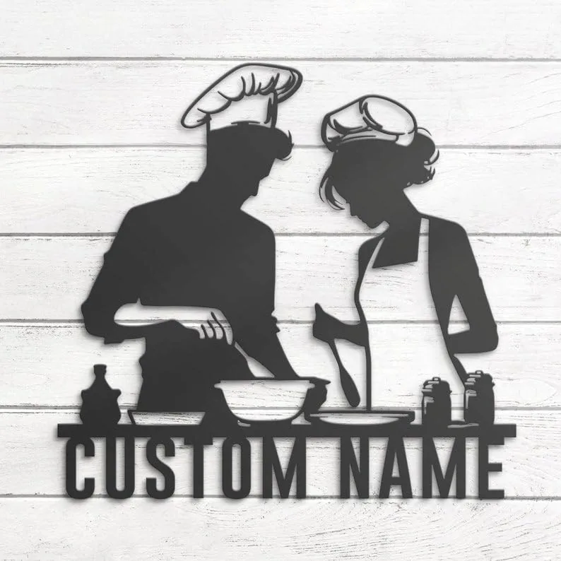 Black metal silhouette of a man and woman chefs cooking together over bowls and utensils with placeholder text "CUSTOM NAME" on a white shiplap wall