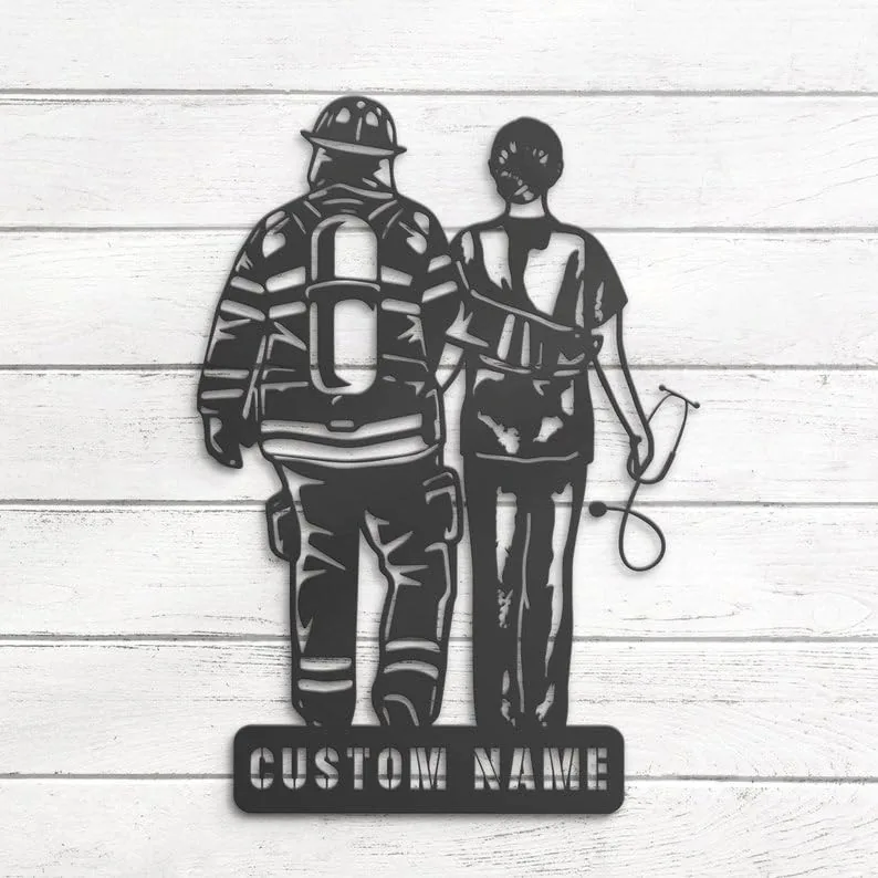 Metal wall art silhouette of a firefighter and nurse standing side by side with a stethoscope and helmet, mounted on white shiplap with a base reading "CUSTOM NAME"