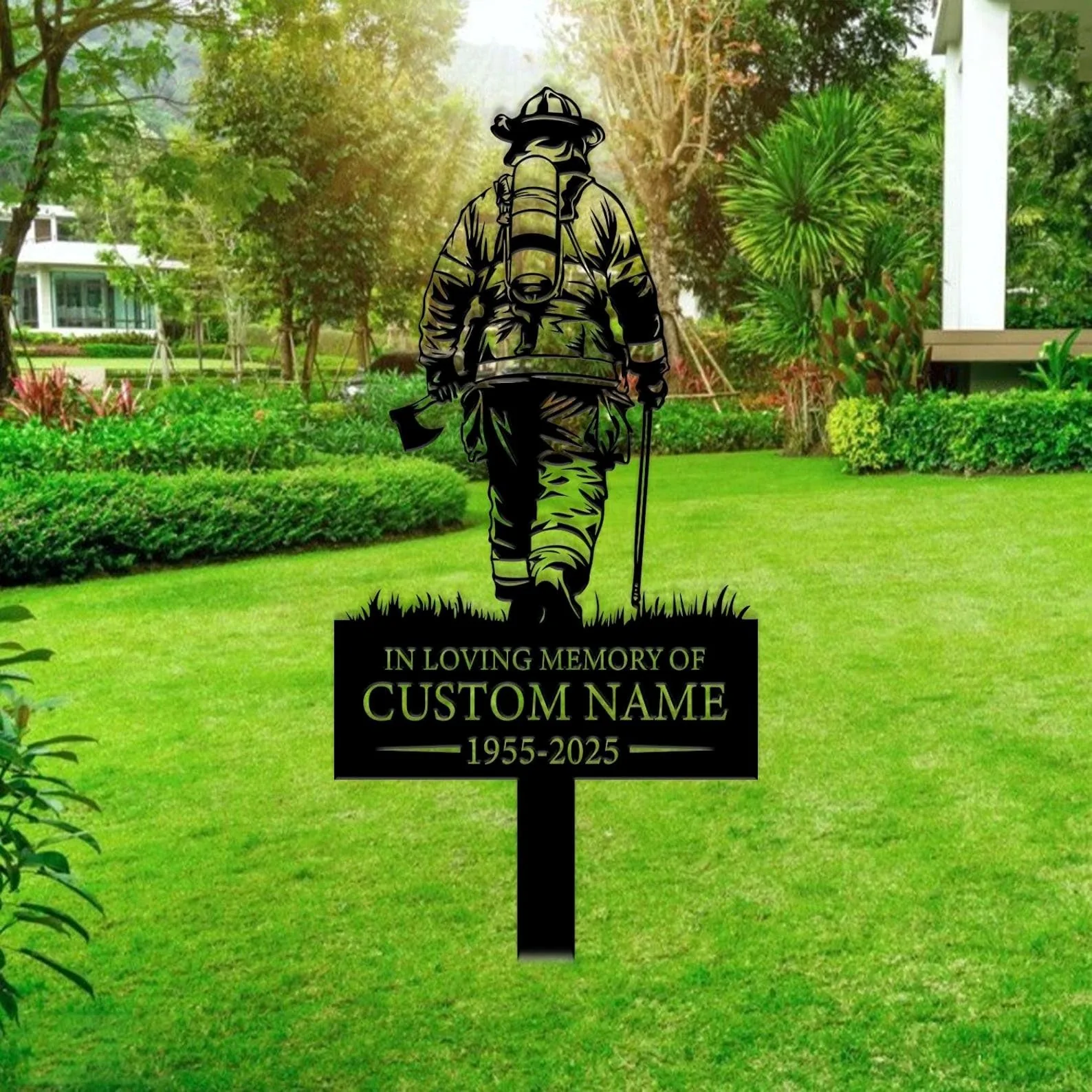 style-13.-Firefighter-Memorial-3 Garden lawn memorial sign showing a silhouetted firefighter with axe and text placeholder “IN LOVING MEMORY OF CUSTOM NAME 1955-2025” in front of green shrubs and trees