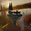 Metal memorial sign with fishing silhouette and pine trees reading "In Loving Memorial Of" and name over a sunset pond with reeds and fishing rods