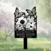 Black metal memorial garden marker with floral and butterfly cutouts reading "In Loving Memory Of HENRY HOYER 12/1/1988 - 11/15/2024" placed in a grassy meadow