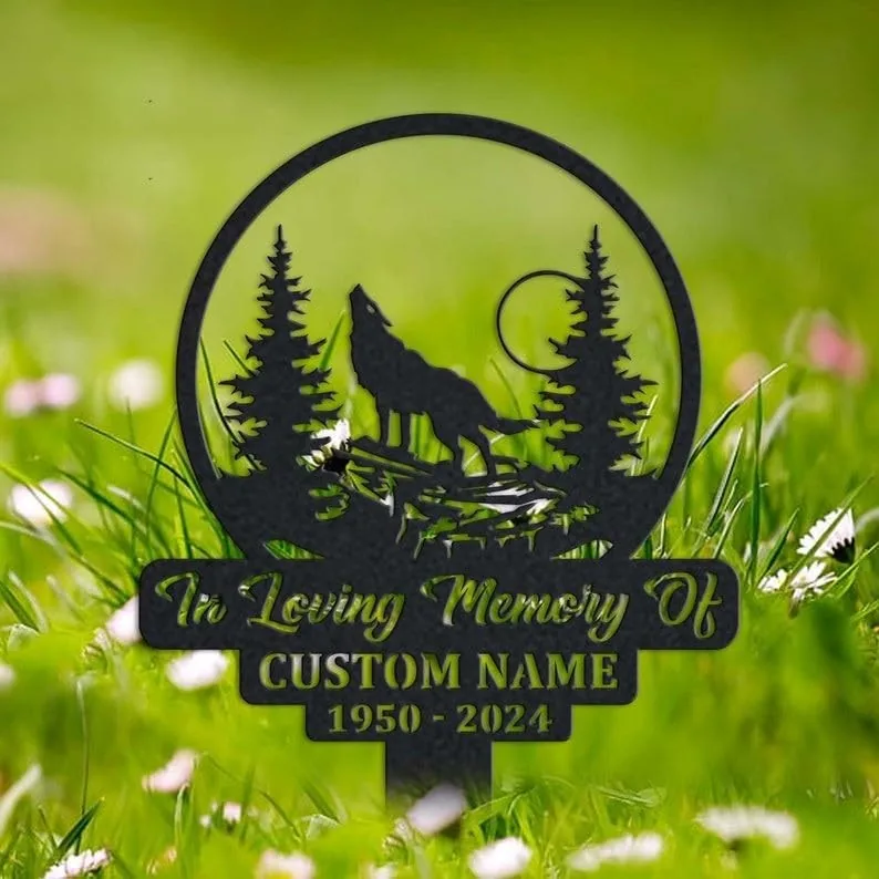 Black metal memorial stake with a howling wolf and trees silhouette reading "In Loving Memory Of" and "CUSTOM NAME 1950 - 2024" placed in grassy lawn
