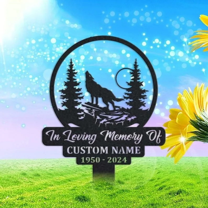 Black metal memorial yard sign with a howling wolf and pine trees, text reading "In Loving Memory Of" with placeholder "CUSTOM NAME 1950 - 2024", staked in grassy lawn