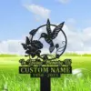 Black metal memorial yard sign with a hummingbird and flower design reading "In Loving Memory Of" and placeholder "CUSTOM NAME 1950 - 2023" against a grassy field
