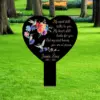 style-25.-Heart-Hummingbirds-2 Black heart-shaped memorial sign in a grassy park with hummingbird and flower illustrations and text reading a short remembrance and the name Jennie Boes 1970 - 2025.