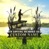 Silhouette lawn memorial sign showing a person fishing from a wooden dock with cattails, over a lake at sunset, text area reading "In Loving Memory Custom Name 1960 - 2023"