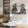 Modern living room wall with metal snowmobile riders sign reading "CUSTOM NAME" above a chair and coffee table