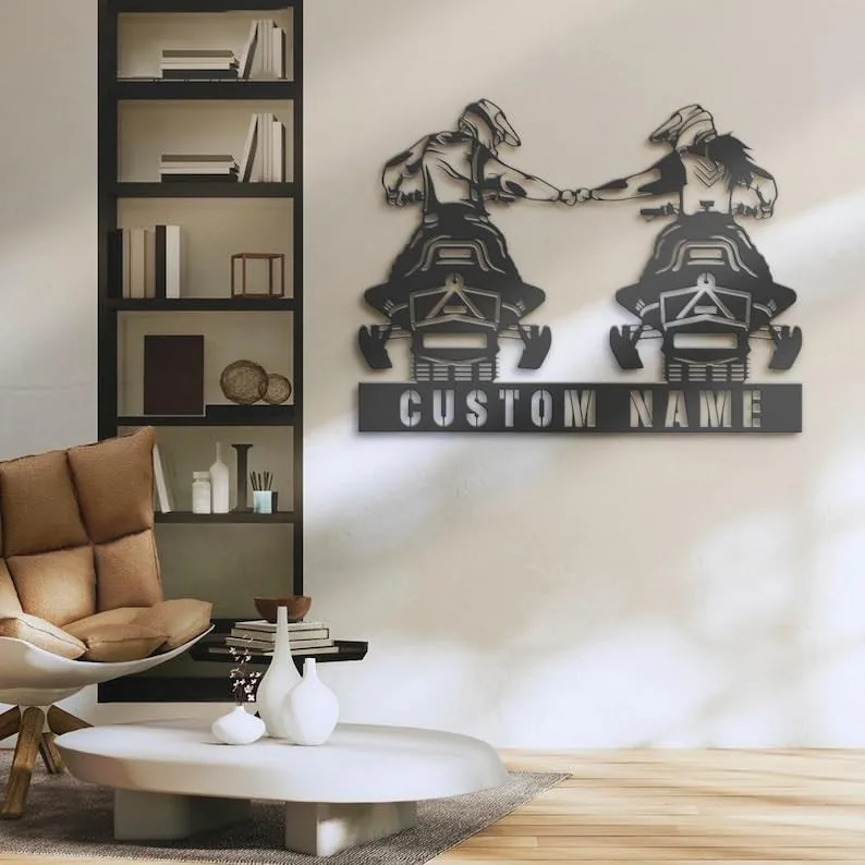 Modern living room wall with metal snowmobile riders sign reading "CUSTOM NAME" above a chair and coffee table