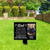 Memorial yard sign reading “Dad” with a photo of an older man and a short tribute placed on a green lawn in front of trimmed hedges and a stone wall