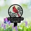 Memorial garden stake with red cardinal illustration and text “When cardinals appear a loved one is near,” personalized name Dylan Hayes 1956-2024, placed among purple flowers