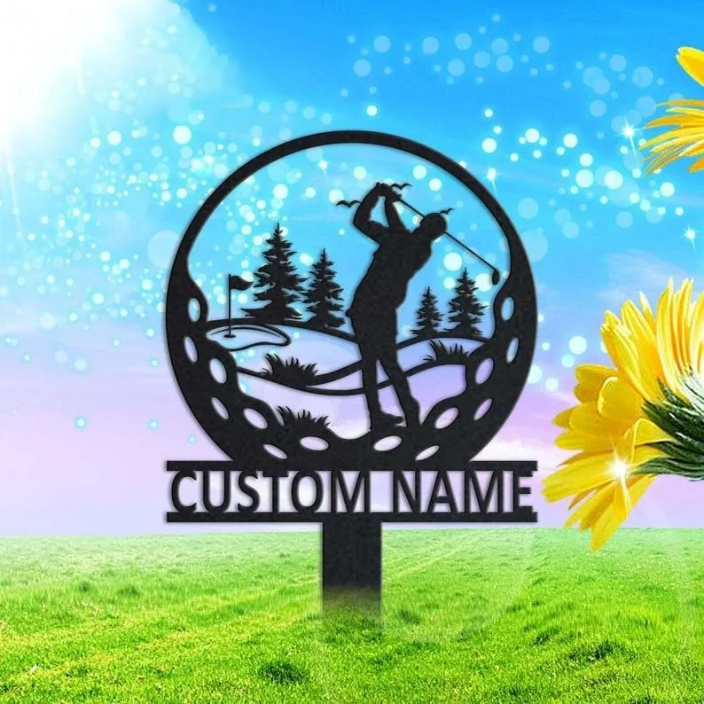 Metal yard sign silhouette of a golfer swinging inside a golf ball shape with trees and flag, mounted stake with text 'CUSTOM NAME' in front of a sunny grassy background