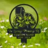 style-36.-Welder-Memorial-1 Black metal memorial garden stake showing a welder in helmet with text 'In Loving Memory Of', customizable name and dates, placed in grassy lawn with flowers