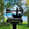Black memorial yard sign with a fisherman silhouette and fish over a lakeshore scene, text reading “In Loving Memory of Jacob Henderson 1956 - 2025,” placed on grassy lakeside under trees