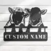 Black metal wall art of two sheep leaning over a fence with one wearing a sunflower crown and stencil text reading CUSTOM NAME on white wood background