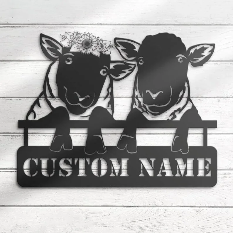 Black metal wall art of two sheep leaning over a fence with one wearing a sunflower crown and stencil text reading CUSTOM NAME on white wood background