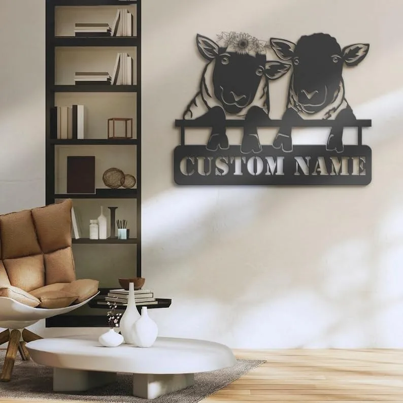 Modern living room with wall-mounted metal sign of two sheep peeking over a fence reading "CUSTOM NAME", neutral decor and bookshelf