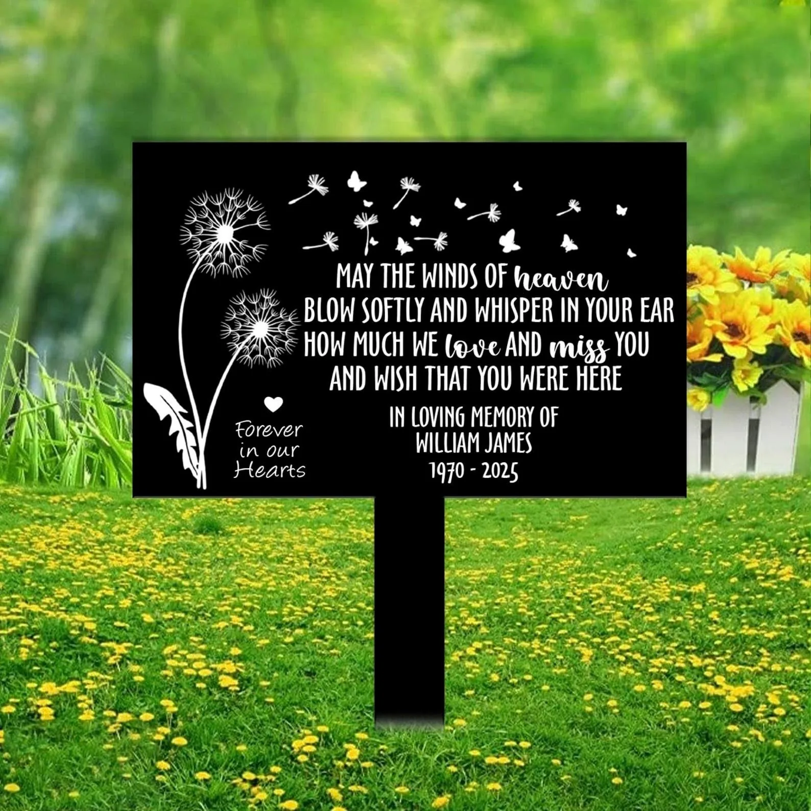 style-40.-Dandelion-Heaven-2 Black memorial sign with white dandelion and butterfly graphics reading “May the winds of heaven blow softly and whisper in your ear how much we love and miss you” and personalized name and dates, placed in a grassy field with yellow flowers