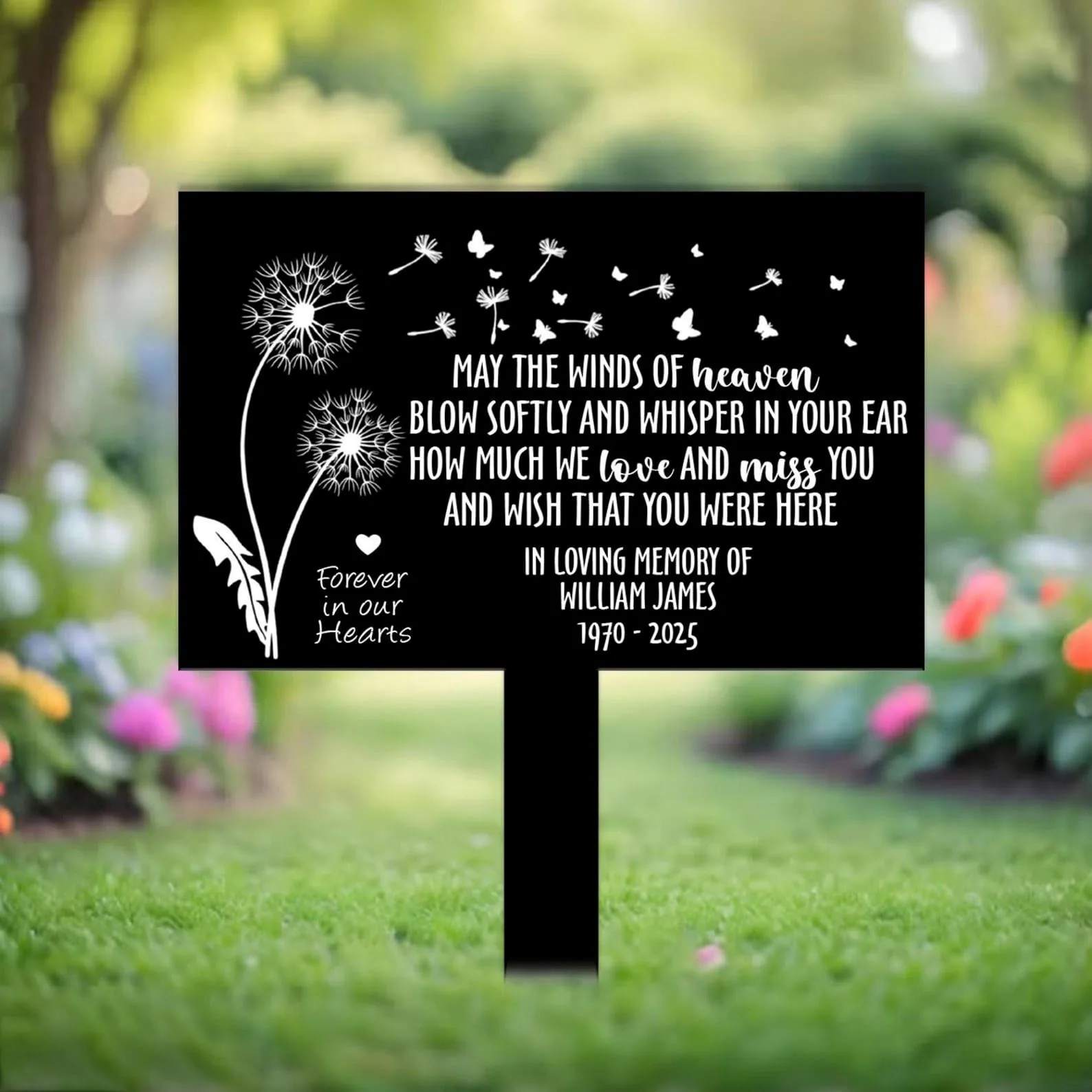 style-40.-Dandelion-Heaven-3 Black memorial yard sign with white dandelion and butterflies design reading a sentimental tribute and "In loving memory William James 1970 - 2025" planted on a grassy garden lawn