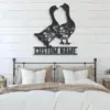 Black metal wall art of two geese with floral cutouts and the words "CUSTOM NAME" mounted above a farmhouse bed with neutral pillows and shiplap wall