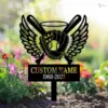 Garden memorial sign with winged baseball glove, bats and ball above a black plaque reading "CUSTOM NAME 1968-2025", placed among colorful flowers