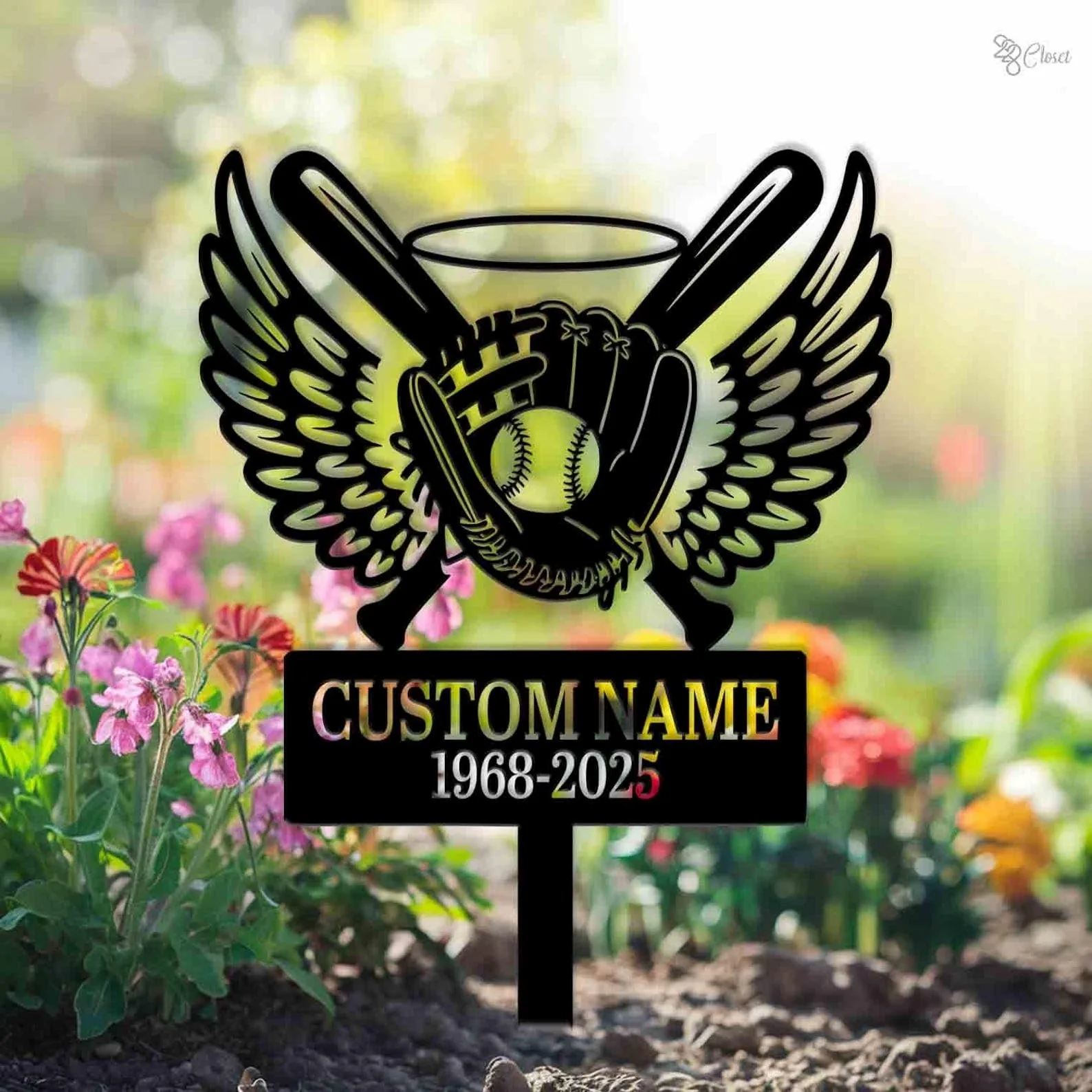 Garden memorial sign with winged baseball glove, bats and ball above a black plaque reading "CUSTOM NAME 1968-2025", placed among colorful flowers