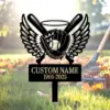 Black memorial yard sign with winged baseball glove holding a ball, crossed bats and halo above, blank custom name and years 1968-2025, set in grassy yard with a rake