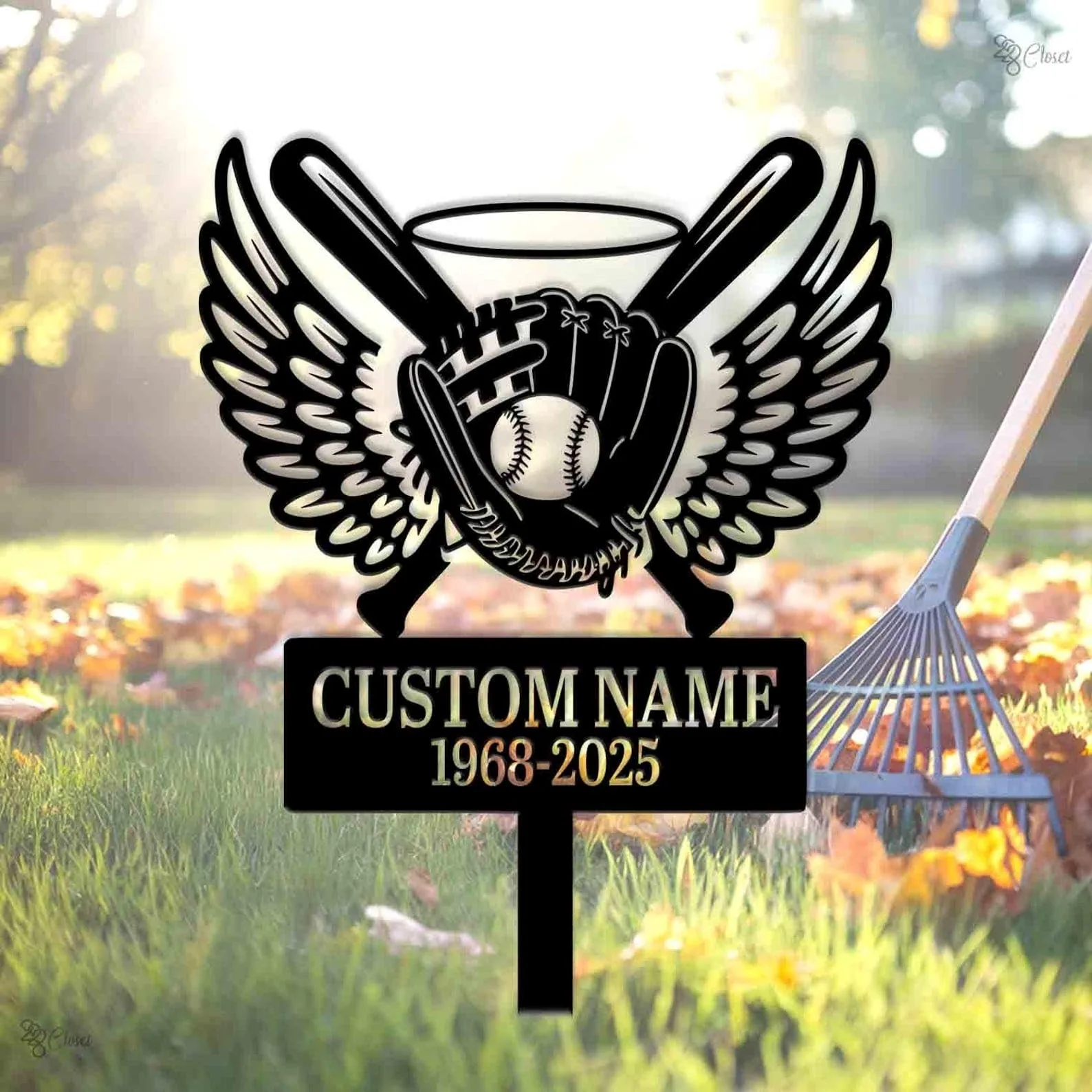 Black memorial yard sign with winged baseball glove holding a ball, crossed bats and halo above, blank custom name and years 1968-2025, set in grassy yard with a rake