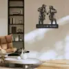 Modern living room with a metal wall art of two motocross riders holding hands above a customizable name plate