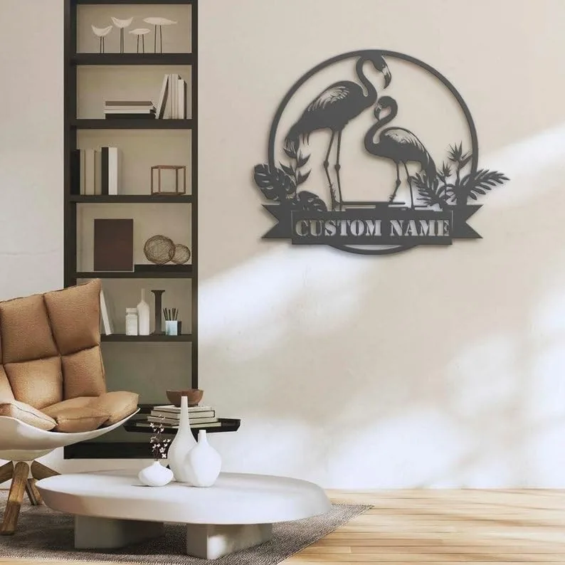 style-8.-Flamingo-Couple-3 Modern living room wall with black metal flamingo wall art reading 'CUSTOM NAME' above a beige chair and low coffee table