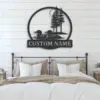 Metal wall art above a bed showing two loons on water with pine trees and the words 'CUSTOM NAME' in a farmhouse bedroom