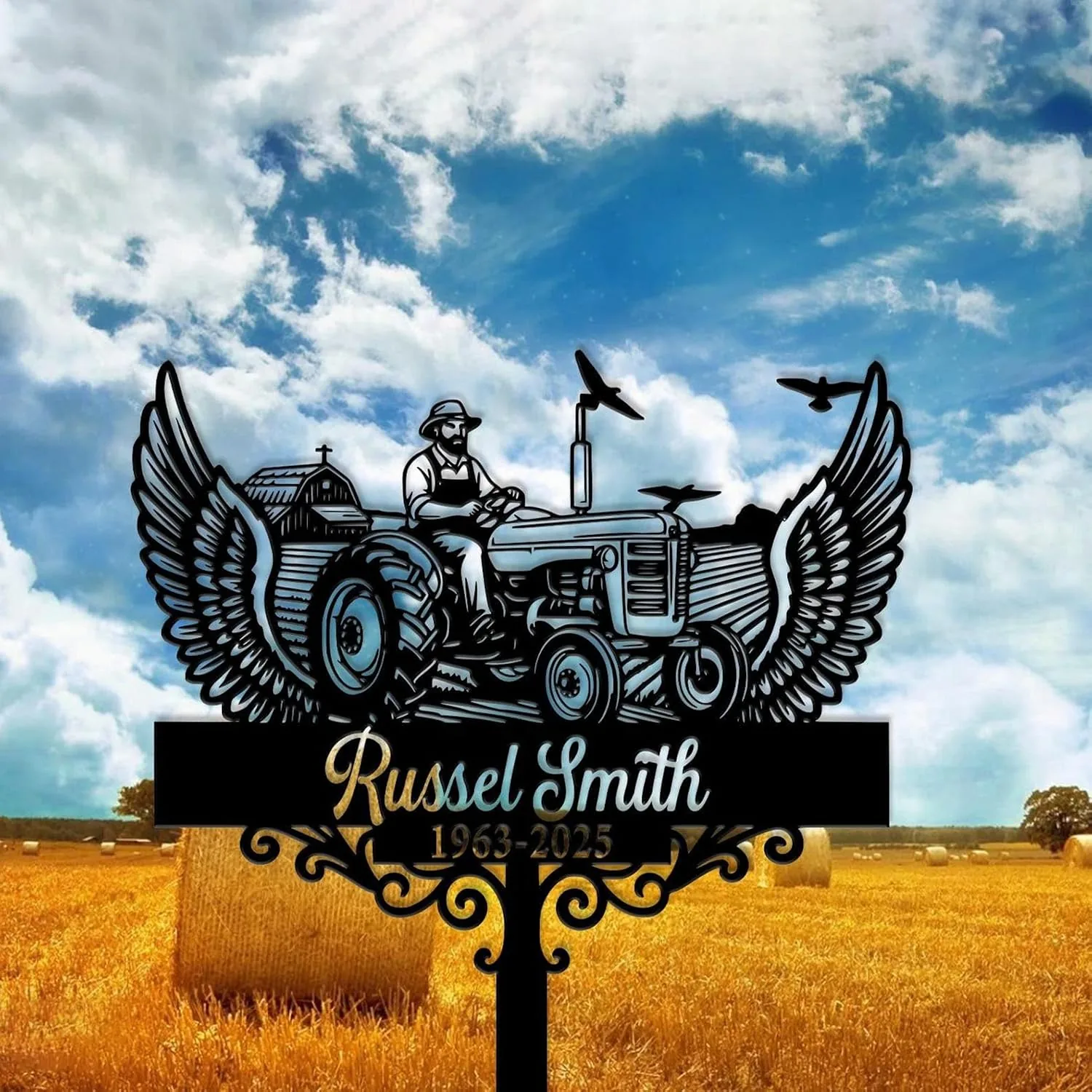 Black metal memorial sign with winged tractor silhouette and a farmer figure above a wheat field, name plaque and dates against a cloudy blue sky