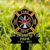 Memorial garden stake with Fire Dept. emblem, firefighter helmet and tools, text 'In Memory Of PAPA 1945 - 2025' on grass background