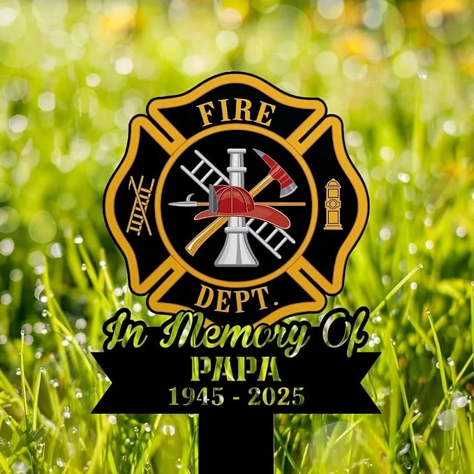 Fire Department memorial yard sign with Maltese cross, helmet, ladder and axe, text "In Memory Of PAPA 1945 - 2025" on grassy background
