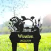 Black garden stake silhouette of a bear with plants and the name "Winston" and date "08.22.2024" staked in grass with blurred trees in background