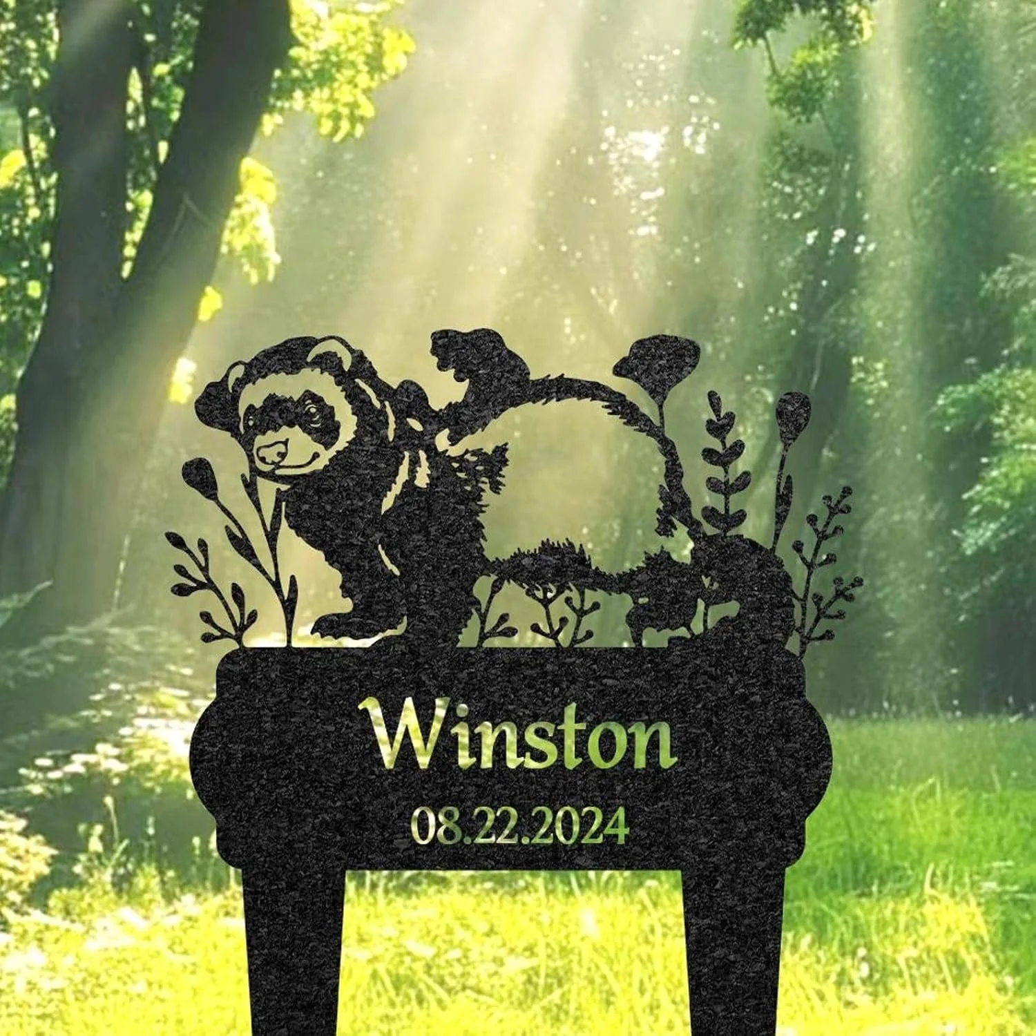 Black silhouette garden sign with a badger and plants above the name 'Winston' and date '08.22.2024' set against a sunlit forest background