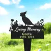 131-2 Black garden memorial stake with cockatoo silhouette and flowers reading "In Loving Memory of Greta 1995 - 2024" placed in grassy yard under blue sky