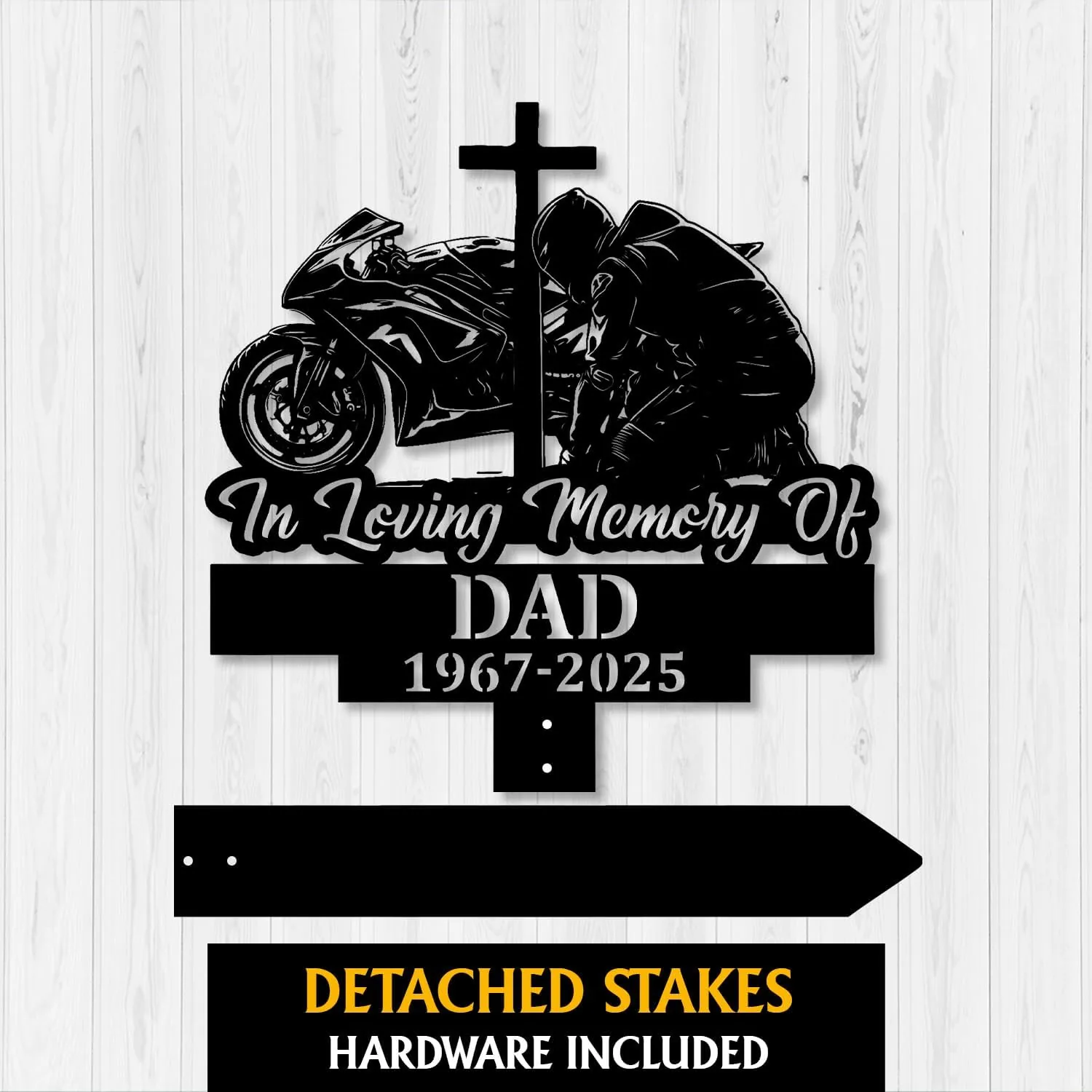 Black metal memorial sign showing a motorcycle and kneeling rider with a cross, text "In Loving Memory Of DAD 1967-2025" on a light wood background