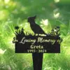 133-2 Black garden memorial stake with cockatoo silhouette and text "In Loving Memory of Greta 1995 - 2024" placed in green grassy outdoor setting